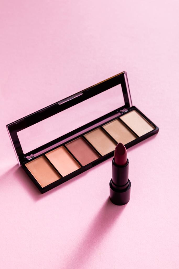 eye shadow palette near lipstick on pink  - Photo, Image