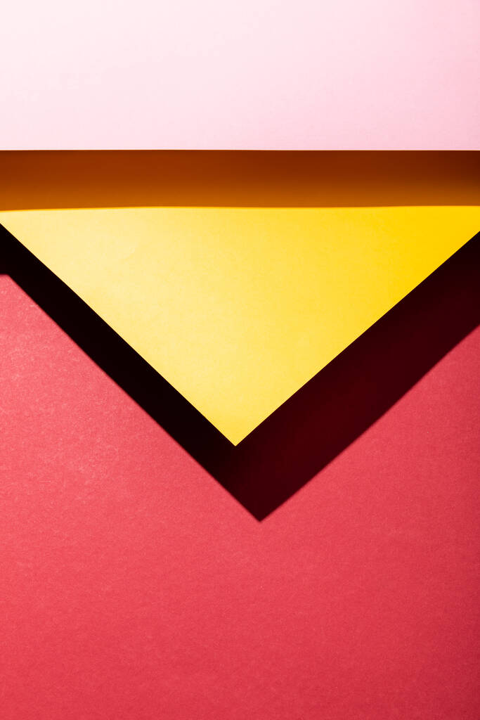 top view of empty pink and yellow paper sheets on crimson  - Photo, Image