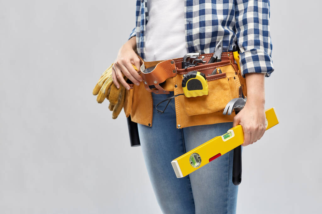 mulher construtor com nível e ferramentas de trabalho na correia - Foto, Imagem