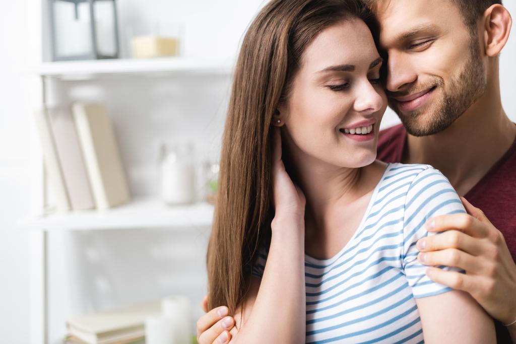happy beautiful young couple hugging at home - Photo, Image