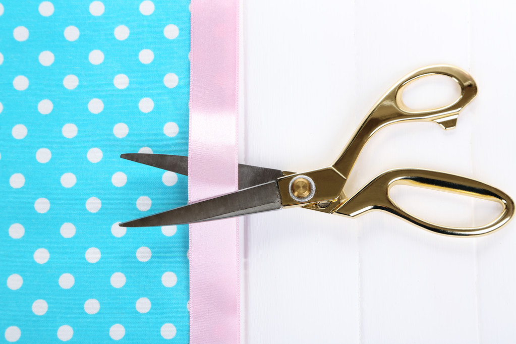 Scissors on color fabric background - Photo, Image