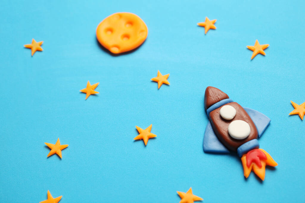 Kid (child) rocket in space, adventure and science. Stars, and moon. Plasticine art, cartoon. - Photo, Image