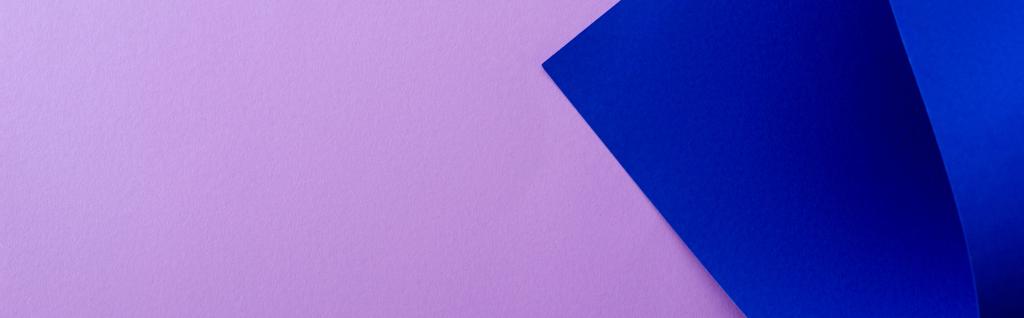 curved blue paper on violet background, panoramic shot - Photo, Image