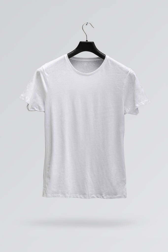 Face avant du t-shirt homme en coton blanc sur un cintre isolé sur fond blanc. T-shirt sans impression - Photo, image