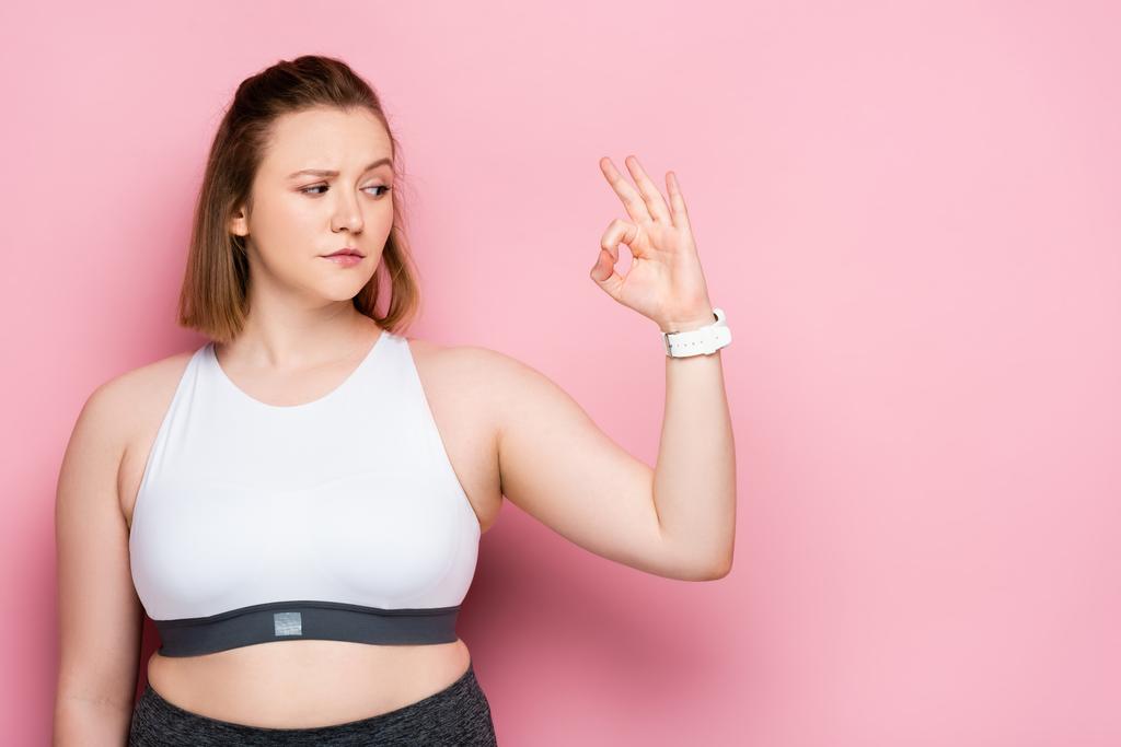 szkeptikus túlsúlyos lány mutatja rendben gesztus rózsaszín - Fotó, kép