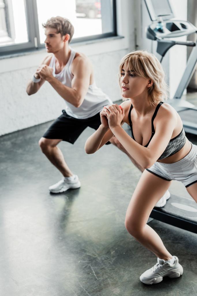 selective focus of young sport couple working out in gym - Photo, Image