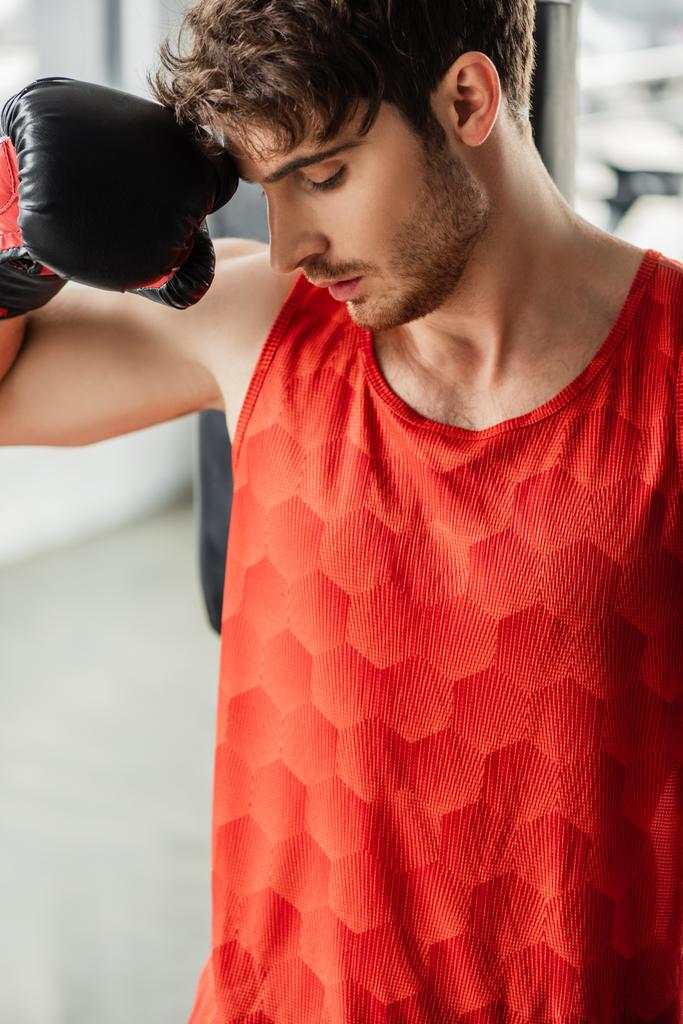 exhausted man in sportswear and boxing glove touching face - Photo, Image