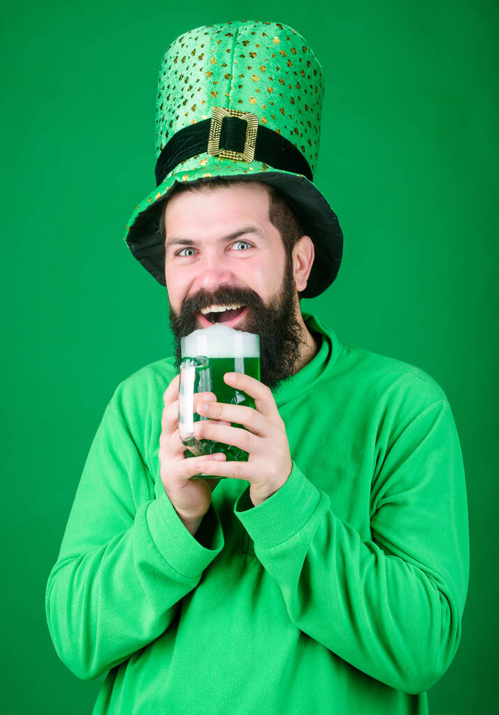 Dyed green traditional beer. Alcohol beverage. Lets start patricks party. Irish tradition. Man brutal bearded hipster drink beer. Irish pub. Drinking beer part celebration. Fest and holiday menu - Photo, Image