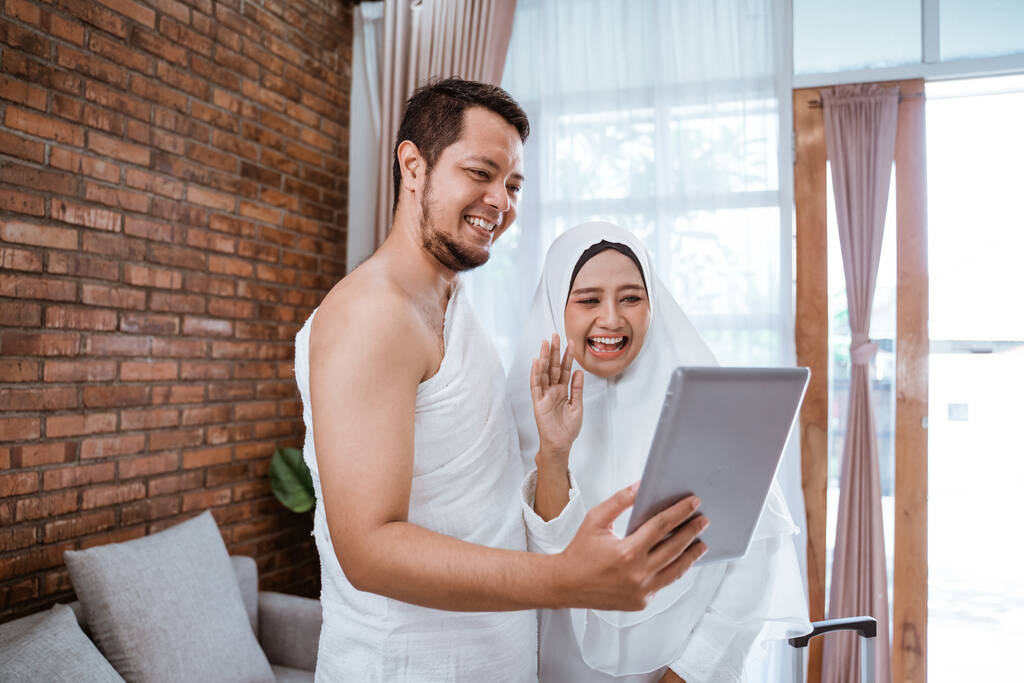 asiático musulmán pareja hajj usando tableta
 - Foto, Imagen
