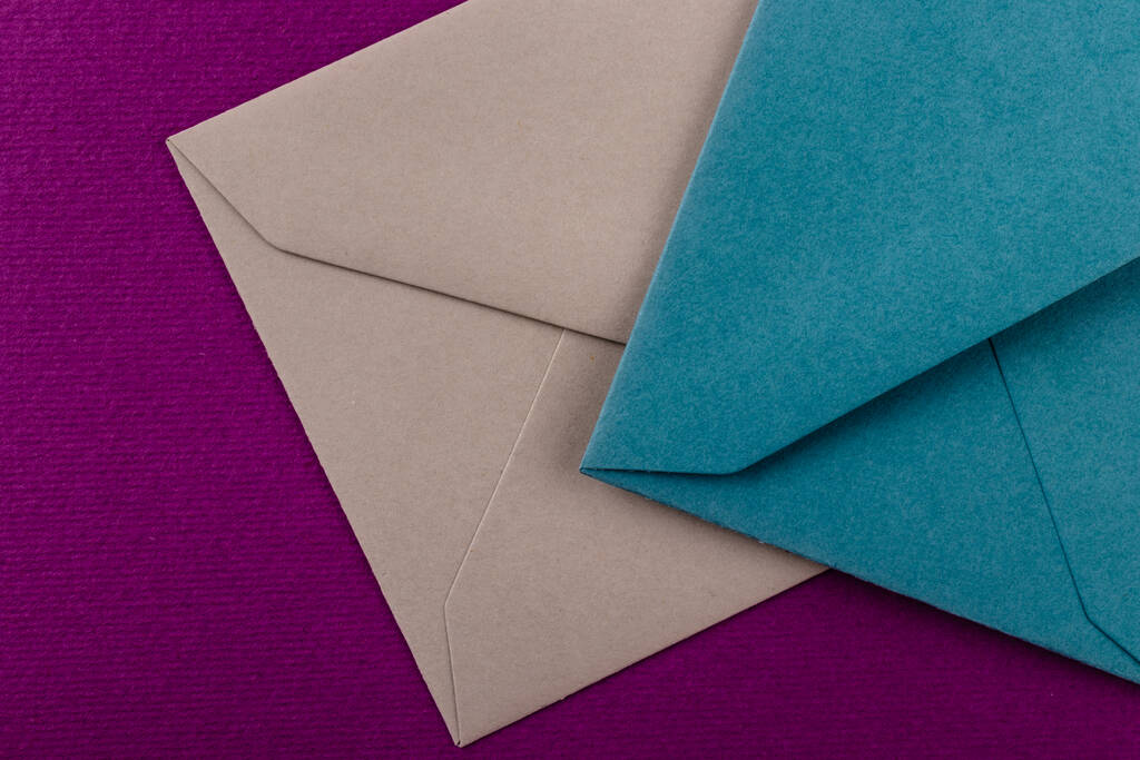 Värikkäitä kirjekuoria violetilla taustalla. Postin kirjekuoret pöydällä. - Valokuva, kuva