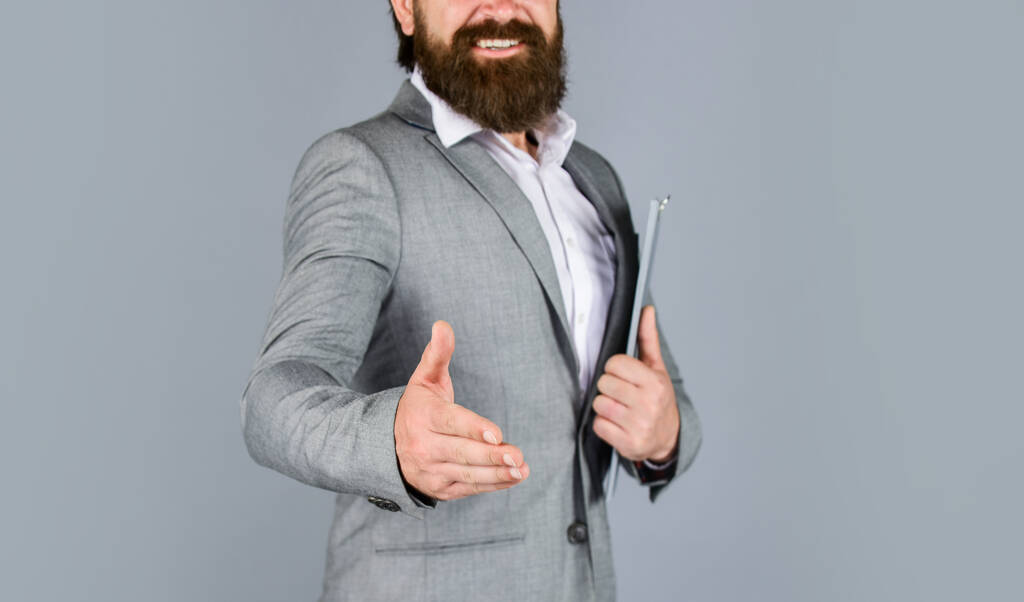 good deal. Pleasant cheerful handsome realtor shaking hands. bearded man working in office. Portrait of successful businessman dressed in formal clothes. serious boss with document. Ready for sale - Photo, Image