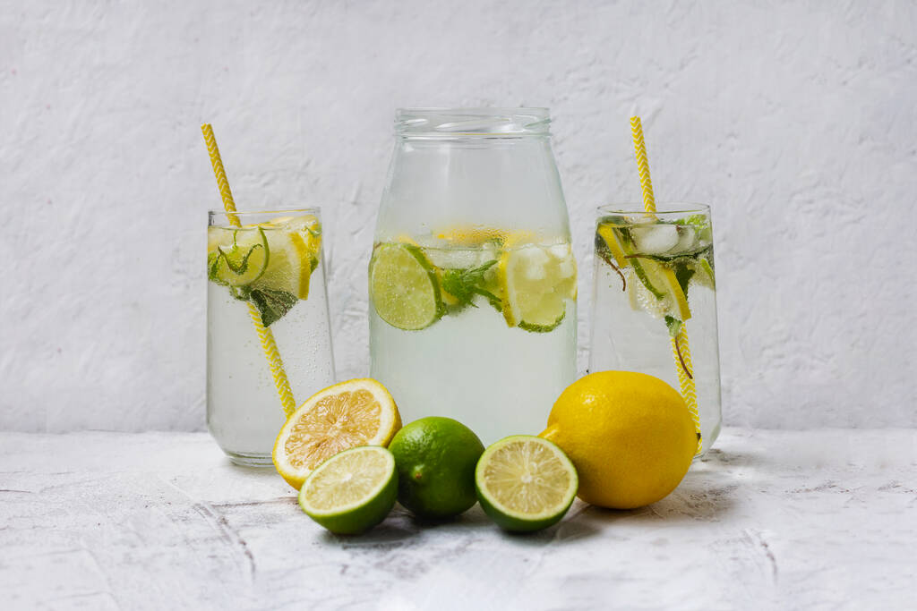 Cold lemonade with ice. Tasty lemonade with lemon, lime and mint. Summer refreshing drink - Photo, Image