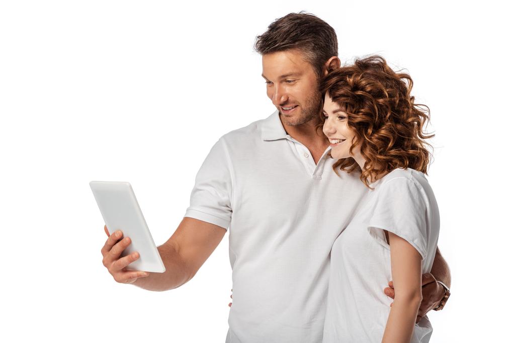 positive couple looking at digital tablet isolated on white  - Photo, Image