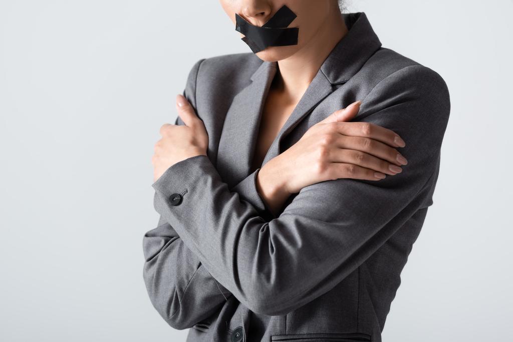 cropped view of businesswoman with scotch tape on mouth standing with crossed arms isolated on white, gender inequality concept - Photo, Image