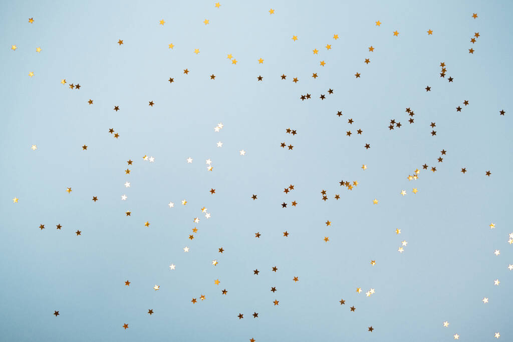 Пастельно-голубой праздничный фон с золотыми звездами блестит confetti.Flat лежать стиль с копировальным пространством для текста, дизайна
 - Фото, изображение
