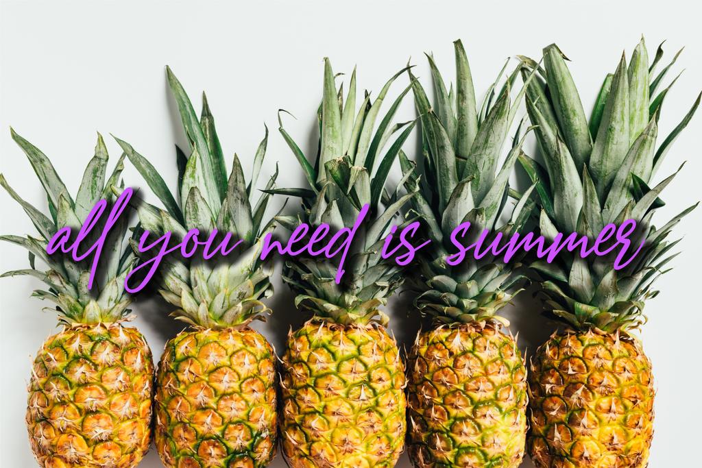 flat lay with fresh ripe pineapples with green leaves on white background with all you need is summer illustration - Photo, Image