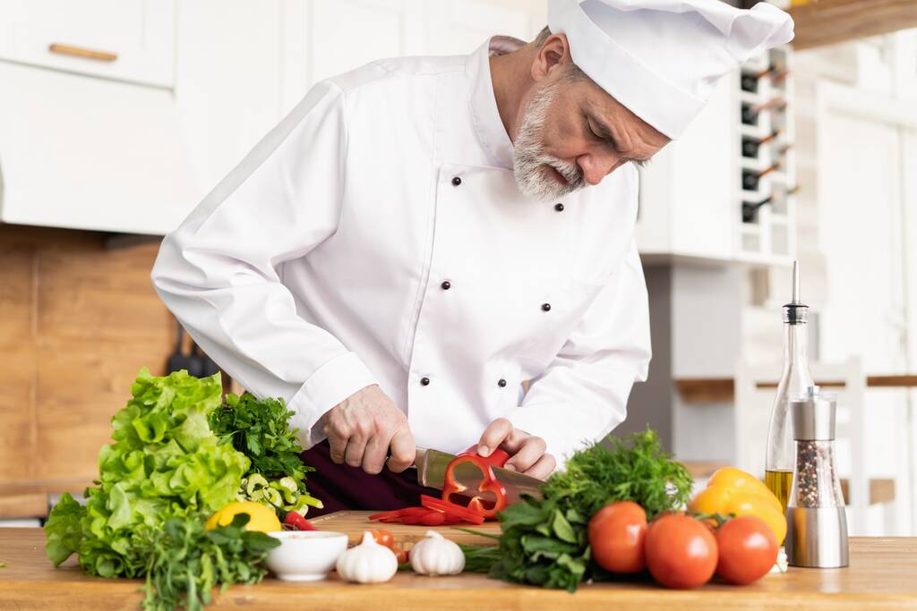 Chef cutting fresh and delicious vegetables for cooking. - Photo, Image