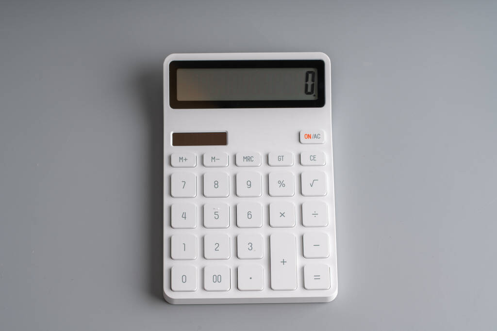 White calculator on grey background for education & business concept - Photo, Image