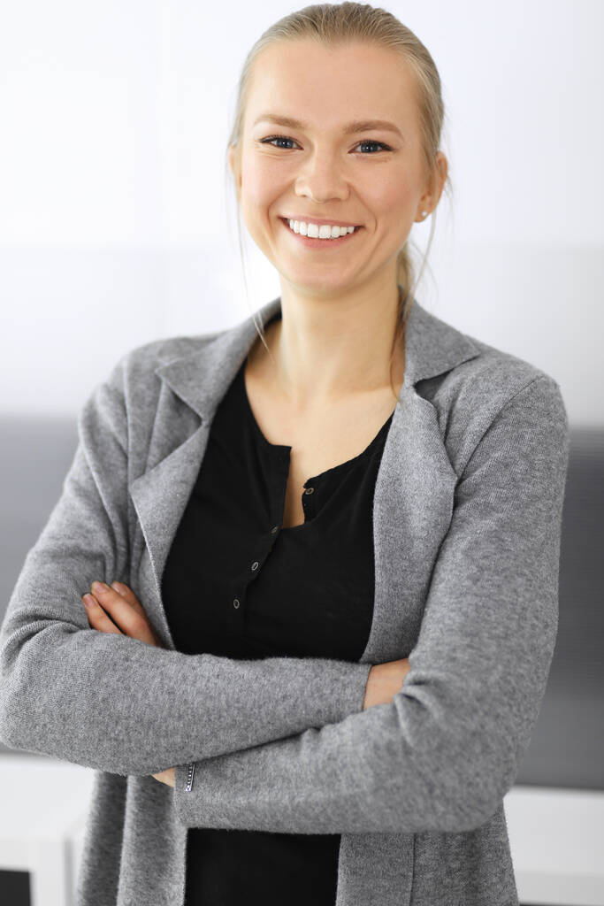 Business woman standing and looking at camera in office. Headshot of casual dressed girl happy smiling - Photo, Image