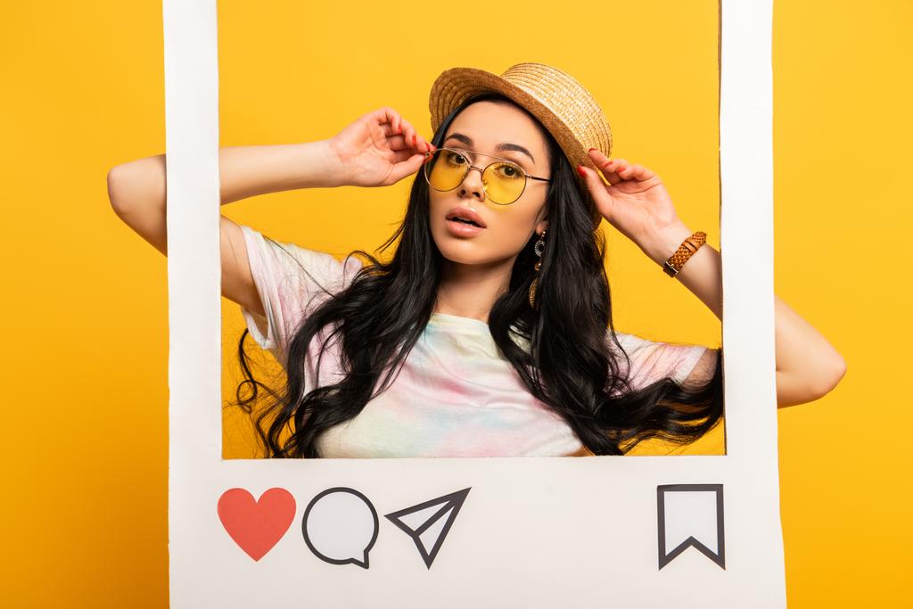 brünettes Mädchen im Sommer-Outfit posiert in sozialem Netzwerk-Rahmen auf gelbem Hintergrund - Foto, Bild