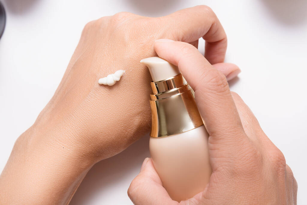 Applying cream to woman hands with dispenser - Photo, Image