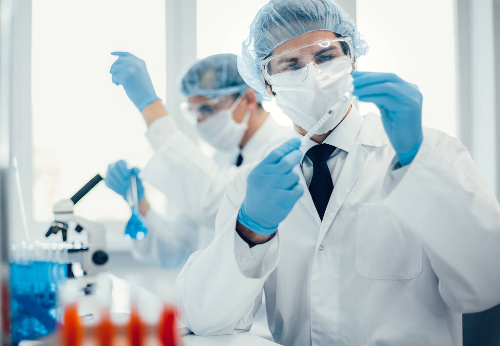 achtergrond beeld van een laboratorium assistent in een medisch laboratorium - Foto, afbeelding