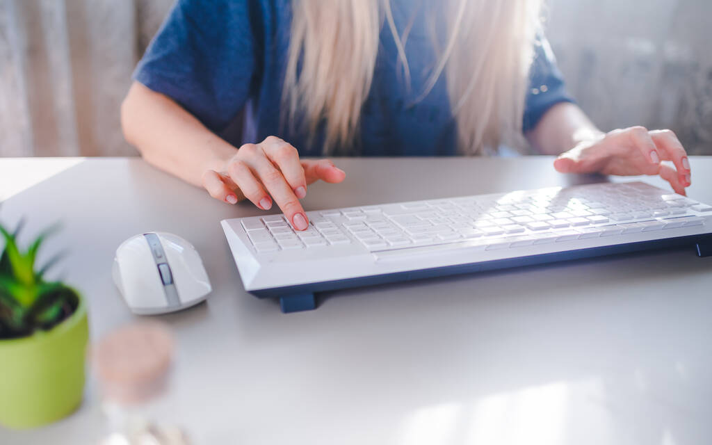 девушка печатает на белой клавиатуре и использует мышь - Фото, изображение