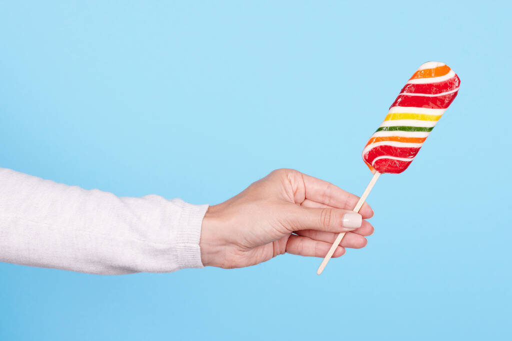 Hand with striped candy cane. - Photo, Image