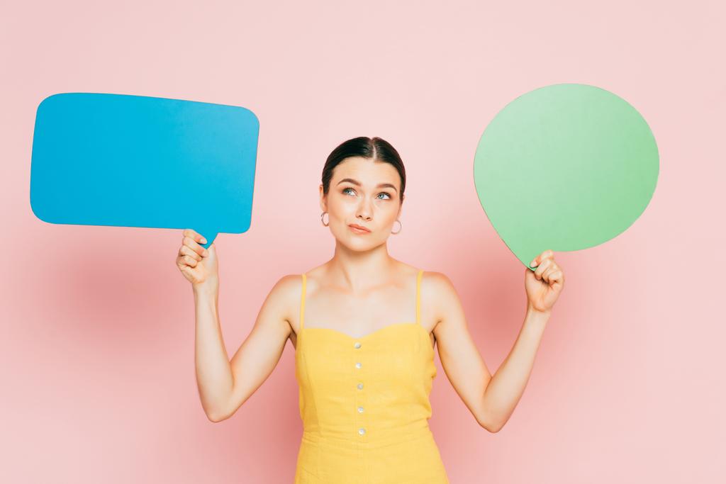 pensive brunette young woman with blank speech bubbles on pink - Photo, Image