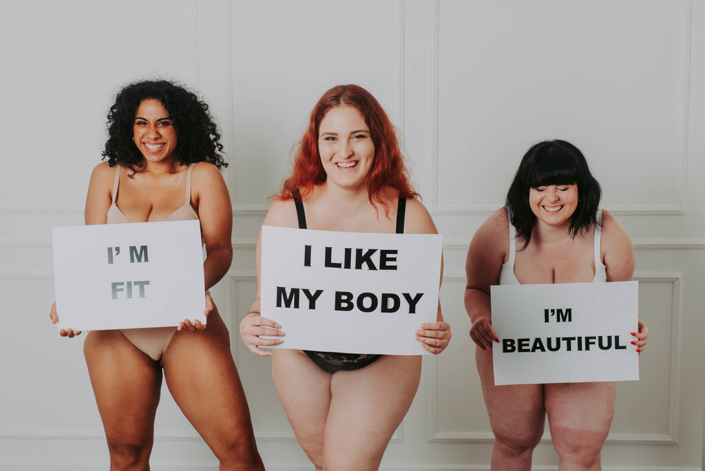 Body acceptance concept.  curvy girl posing in studio against society prejudice - Photo, Image