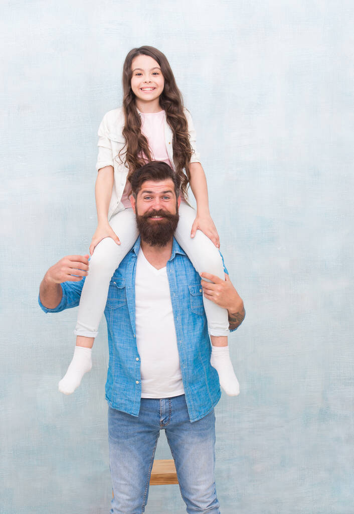 Do what you like. Baby girl enjoy active game with father. Bearded man piggyback small child. Casual look of happy family. Casual wear. Fashion trends. Trendy style. Hair salon. Barbershop - Photo, Image