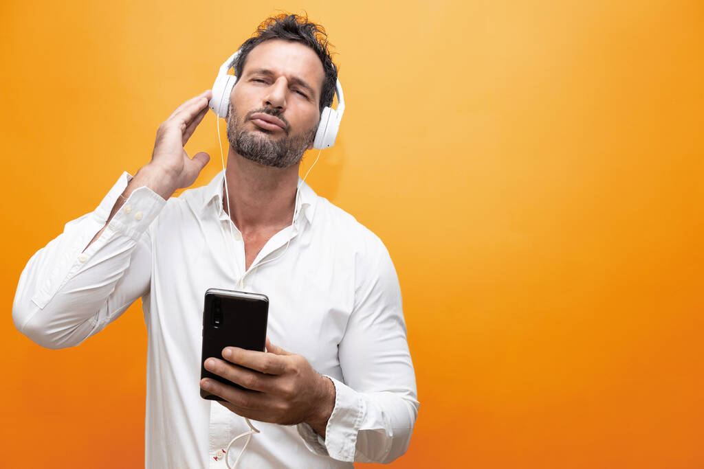 man listening to music with headphones. he is gesturing and dancing - Photo, Image