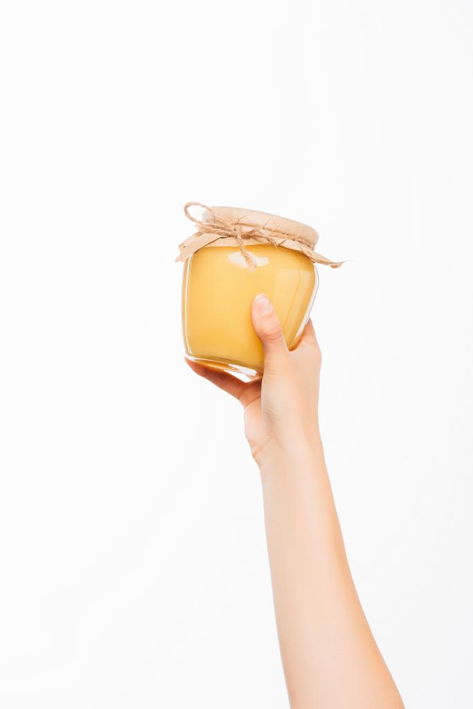 abgeschnittene Ansicht einer Frau mit einem Glas Honig auf weißem Hintergrund, Charity-Konzept - Foto, Bild