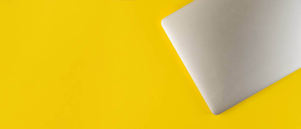 Top view of laptop and mouse on yellow background.Flat lay composition with notebook and mouse on yellow background - Photo, Image