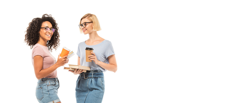 Horizontal crop of multicultural students holding books and coffee to go isolated on white - Photo, Image