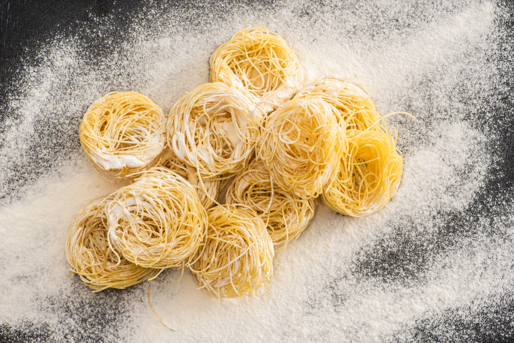 top view of raw Capellini pasta in flour - Photo, Image