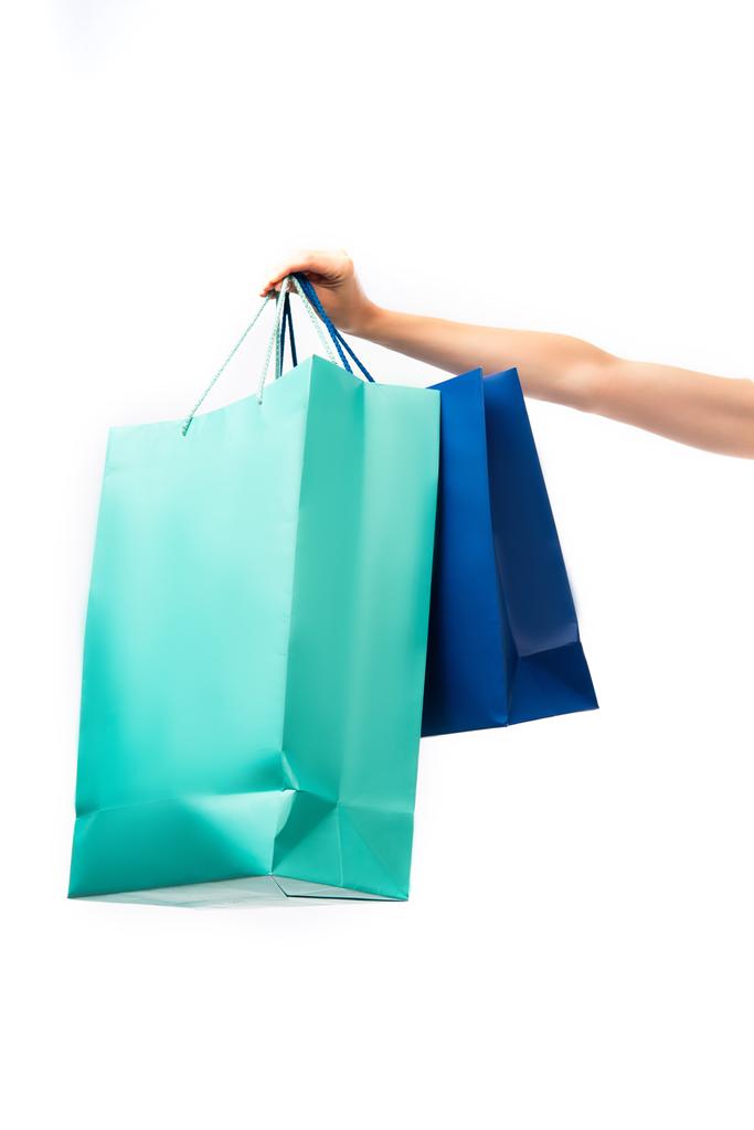 przycięty widok kobiety trzymającej kolorowe torby na zakupy odizolowane na biało  - Zdjęcie, obraz
