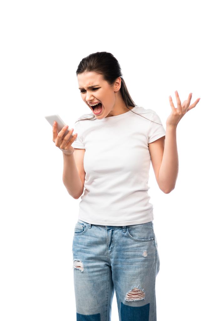 nespokojená žena křičí a drží smartphone izolované na bílém  - Fotografie, Obrázek
