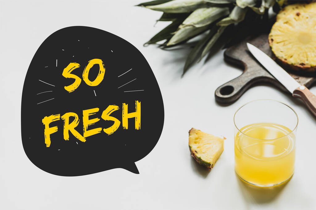 delicious pineapples on wooden cutting board with knife near glass of orange juice and so fresh lettering on white  - Photo, Image