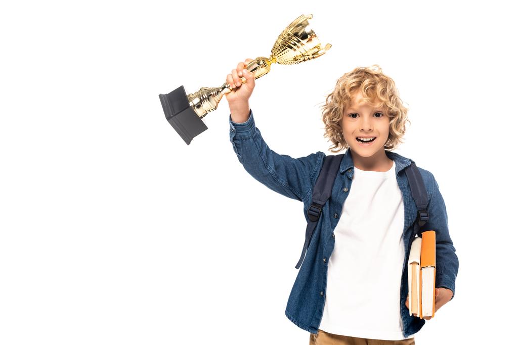 blonde schoolboy holding golden trophy and books isolated on white  - Photo, Image