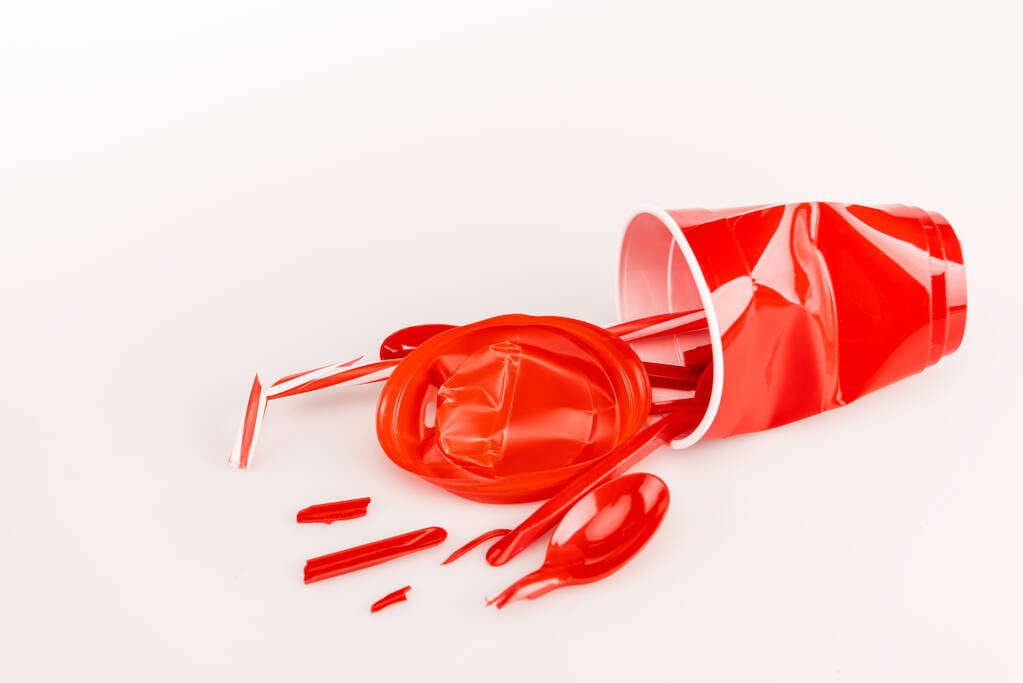 broken red plastic objects on white background - Photo, Image