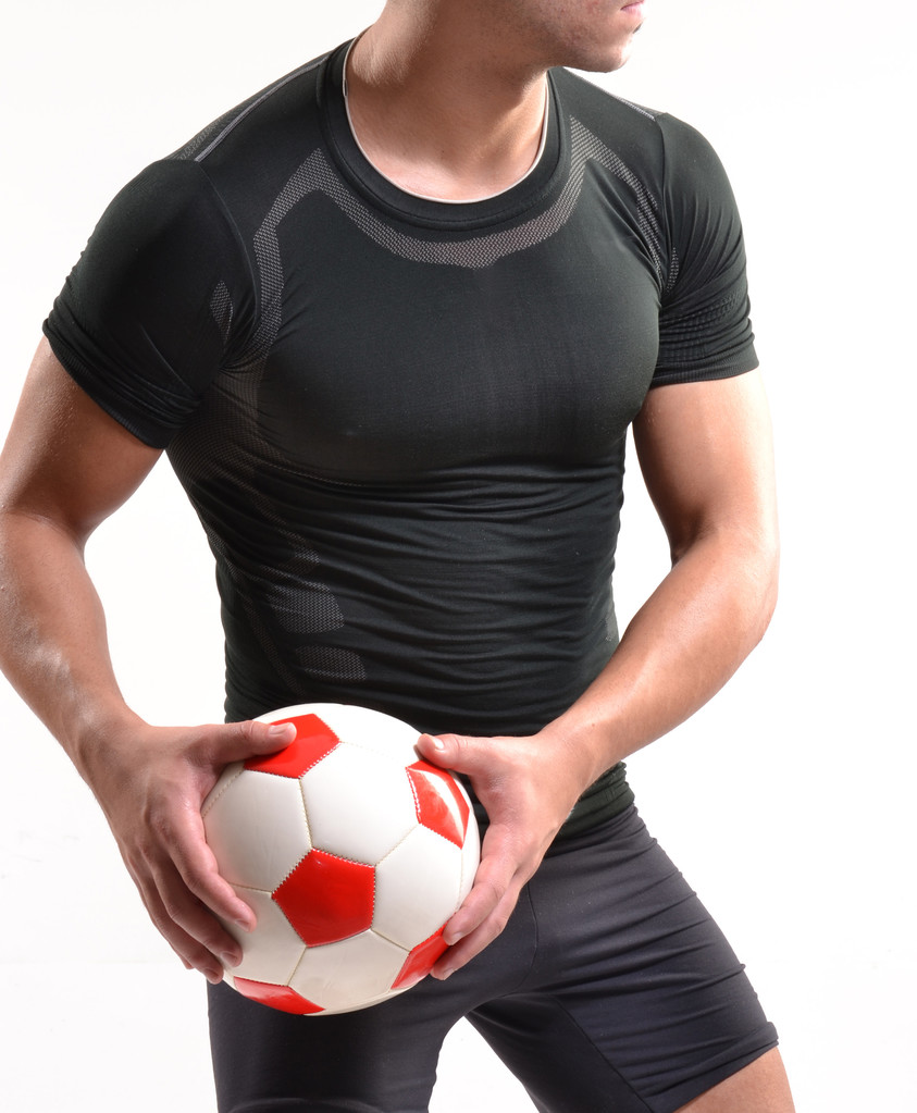 γυμναστήριο ποδοσφαιριστής και μια μπάλα ποδοσφαίρου. - Φωτογραφία, εικόνα