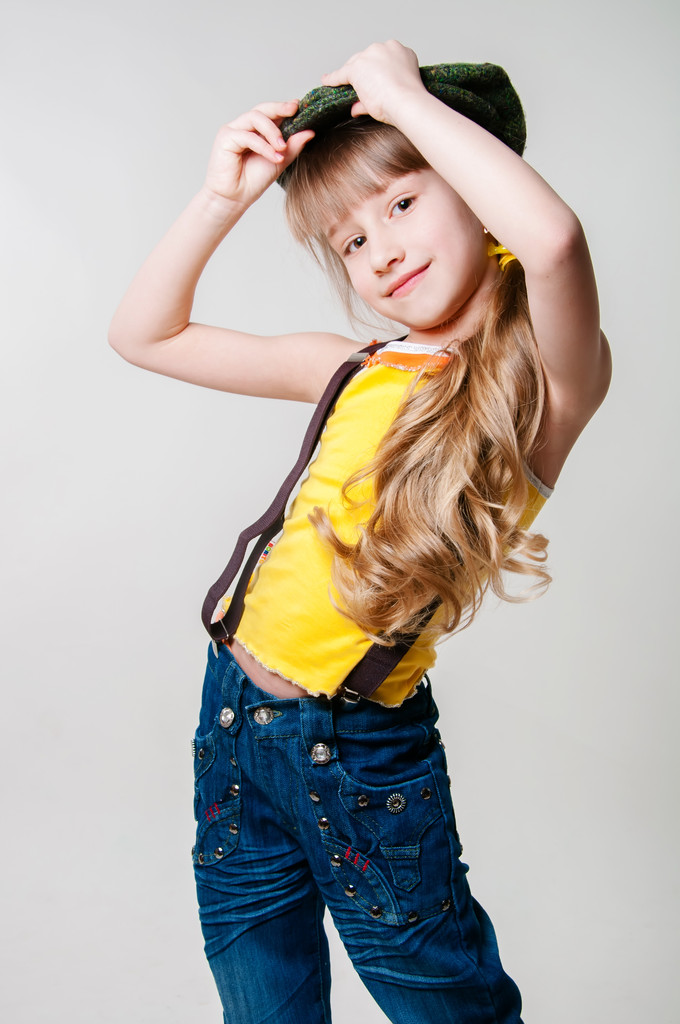 Little girl in jeans on a white background - Photo, Image