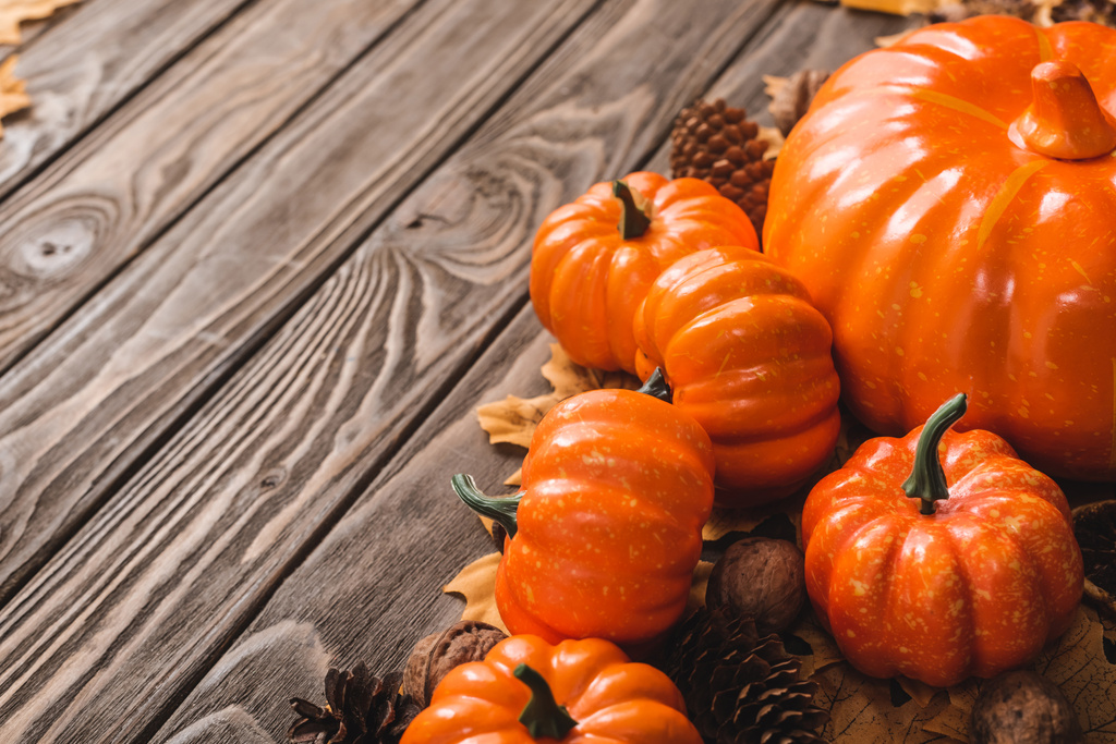 autumnal decoration and pumpkins on brown wooden background - Photo, Image