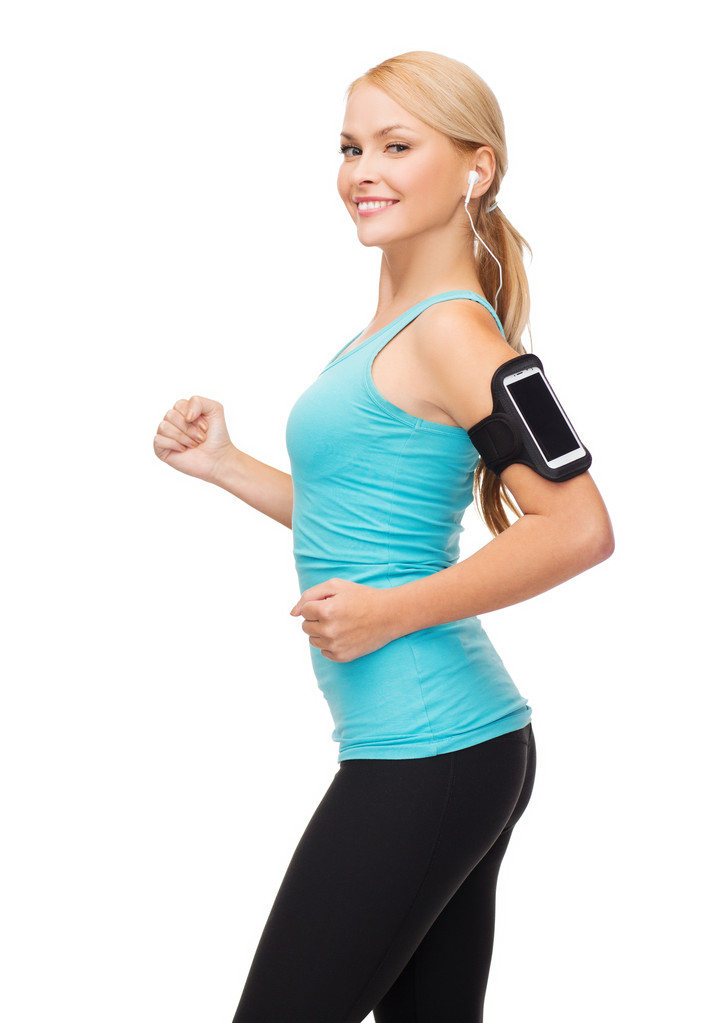 Mujer deportiva corriendo con smartphone y auriculares
 - Foto, imagen