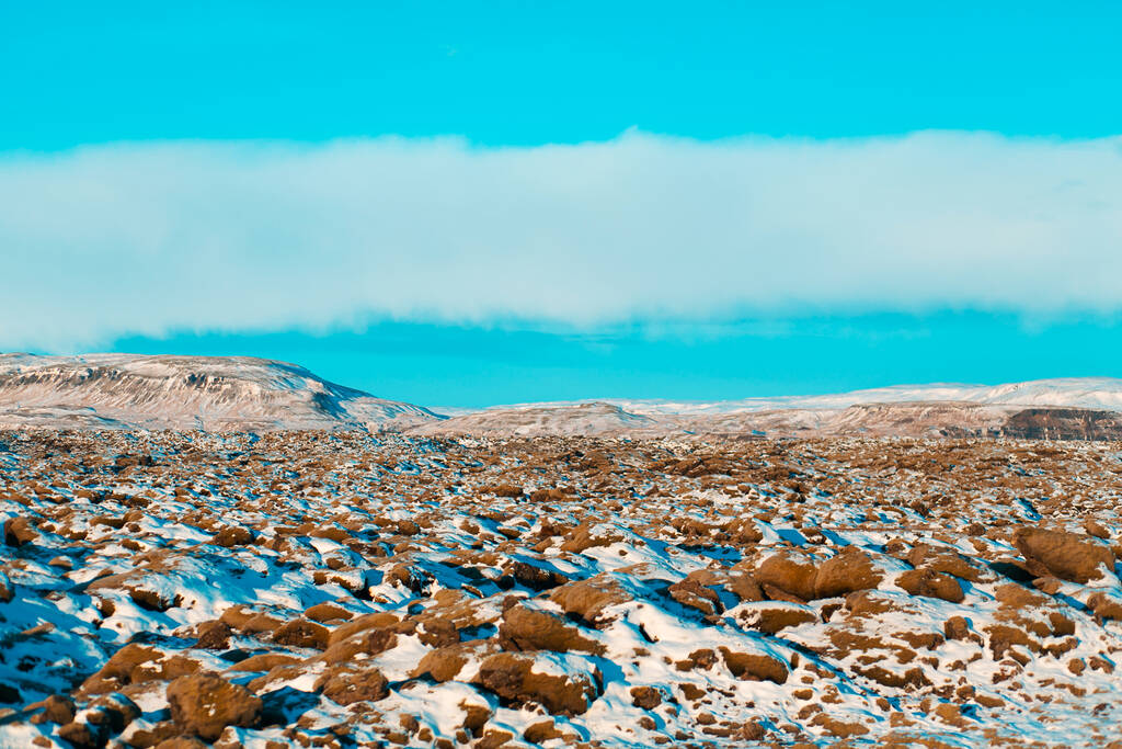 Зимний пейзаж в Исландии. Поле затвердевшей лавы, покрытое мхом, покрыто снегом - Фото, изображение