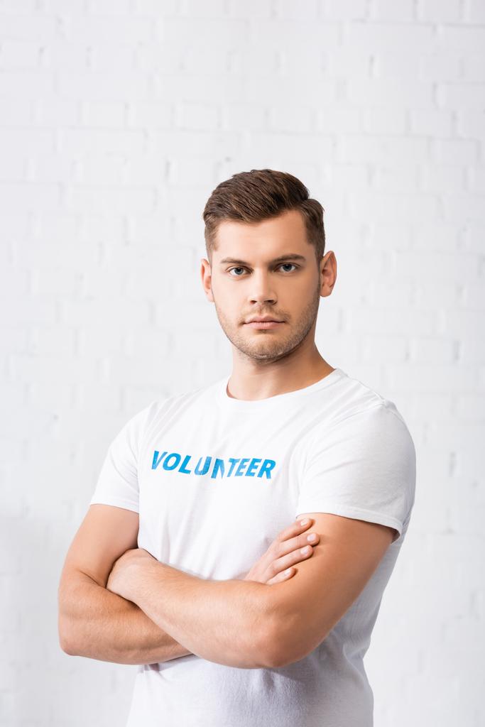 Confident volunteer with crossed arms looking at camera  - Photo, Image