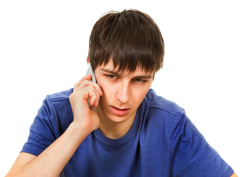 Nuori mies puhuu puhelimessa Eristetty valkoisella taustalla - Valokuva, kuva