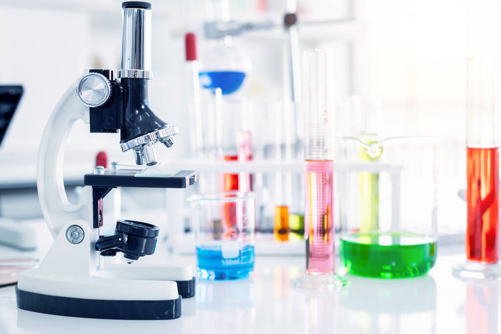 Microscope and test tubes with lab glassware in laboratory background, research and Scientific concept - Photo, Image