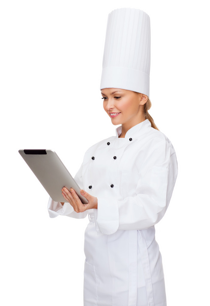 glimlachend vrouwelijke chef-kok met tablet pc-computer - Foto, afbeelding